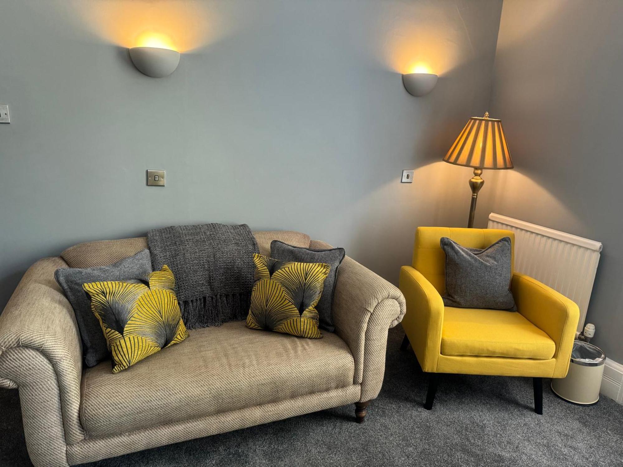 The Red Lion Hotel Cromer Luaran gambar A living room with a sofa and a chair